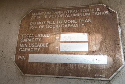Peterbilt 567 engine bay label showing tank strap torque and liquid capacity values