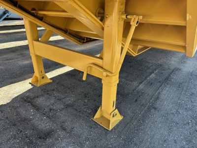 Trailer landing gear and undercarriage of a yellow 20 ton equipment trailer showing support legs and frame details.