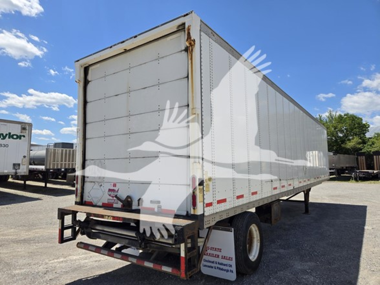 Trailer side and rear view of a white 2014 Wabash van trailer showing rear doors and reflective red/white tape.