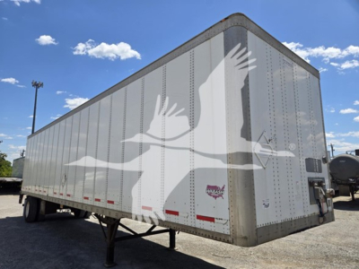 Wabash van trailer side view showing large eagle graphic and loading ramps in back, metal riveted panels, chrome corner trim, and wheel-less front landing gear.