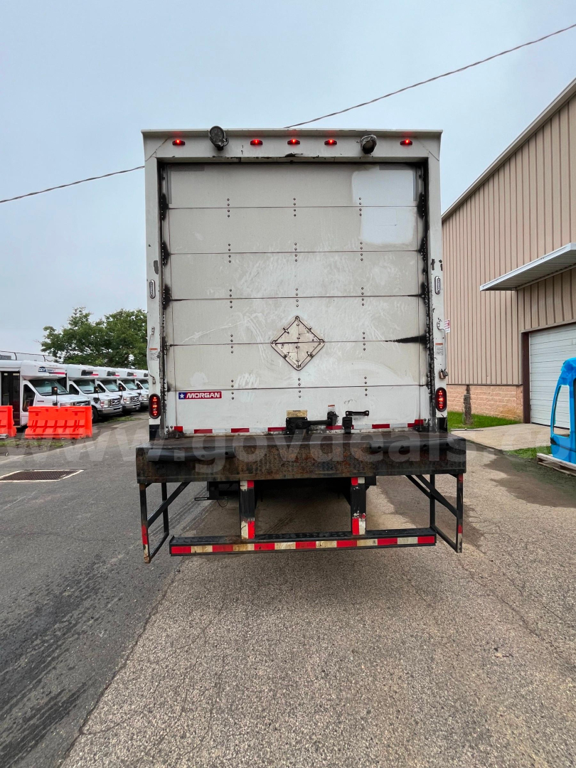 Back view of a 2004 International 4300SBA box truck showing rear doors and bumper with warning decals.