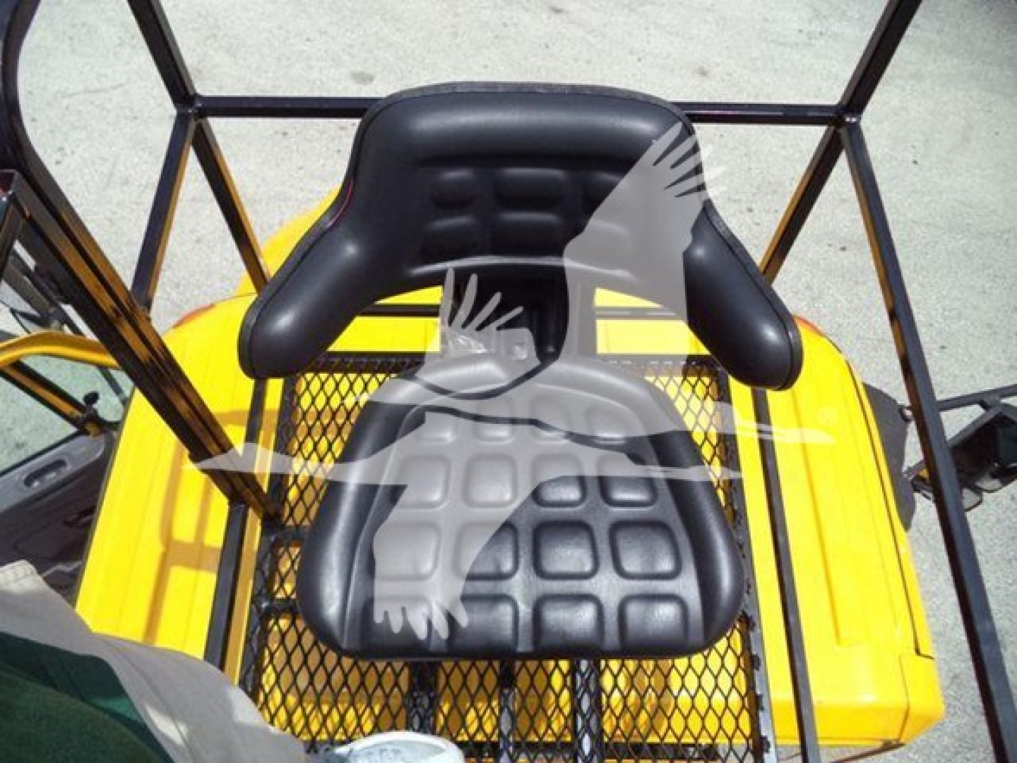 Seat unit in a 2019 International Durastar grapple truck cab showing black padded seat with mesh backrest and surrounding orange body panels.
