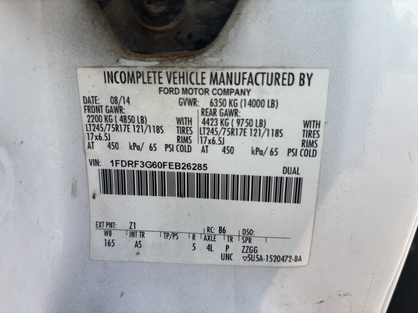 Label on Ford F-350 chassis showing vehicle manufacturing data: INCOMPLETE VEHICLE MANUFACTURED BY FORD MOTOR COMPANY, VIN 1FDRF3G60FEB26285, GVWR 6350 KG (14000 LB), GAW 6350 KG (14000 LB), front GAWR 2200 KG (4850 LB), rear GAWR 4423 KG (