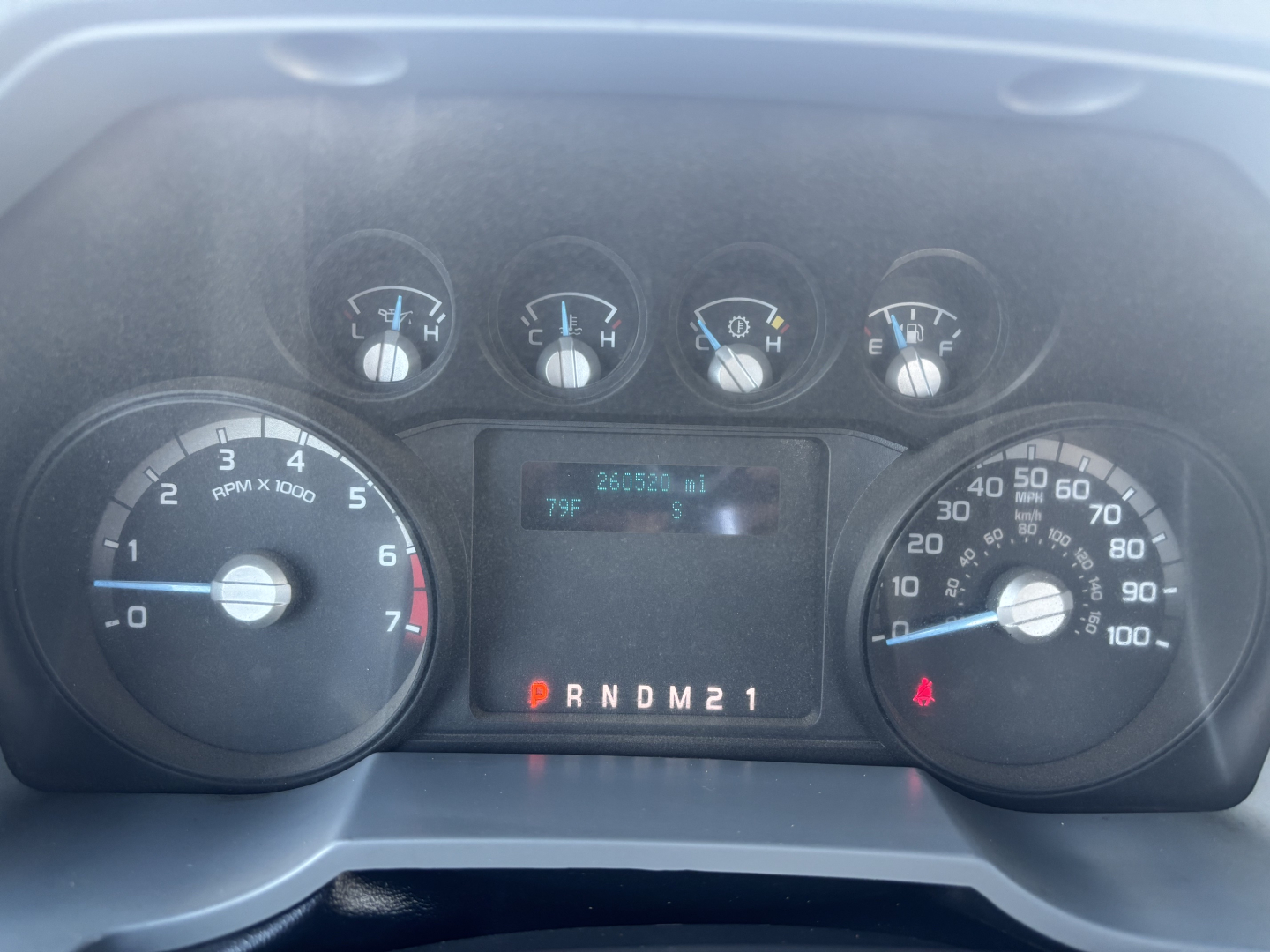 Ford F-350 cab and chassis dashboard showing instrument cluster with speedometer, tachometer, and center digital display; gear indicator PRNDM21; odometer reading 226502 miles; various warning/aux gauges.