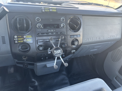Dashboard of a 2015 Ford F-350 cab and chassis showing the radio, climate controls, and ram-mount with three arms.