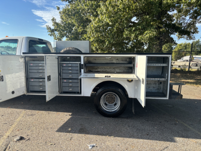 Ford F-350 utility/service bed side view showing multiple tool drawers and open compartments