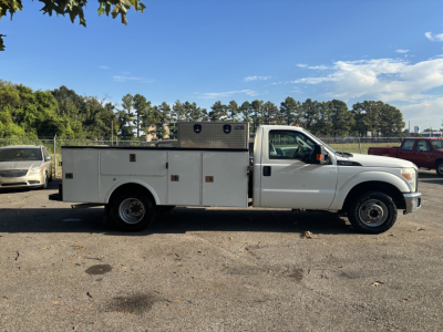 Ford F-350 utility/service truck side view showing service body with diamond storage compartments and overhead toolbox.