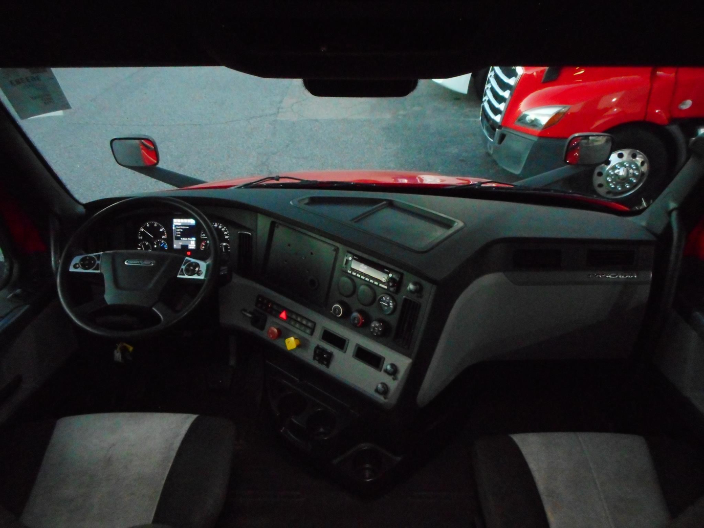 2020 Freightliner Cascadia 116 interior dash view showing steering wheel, dashboard, and center console. VIN/stock label details not visible in image.