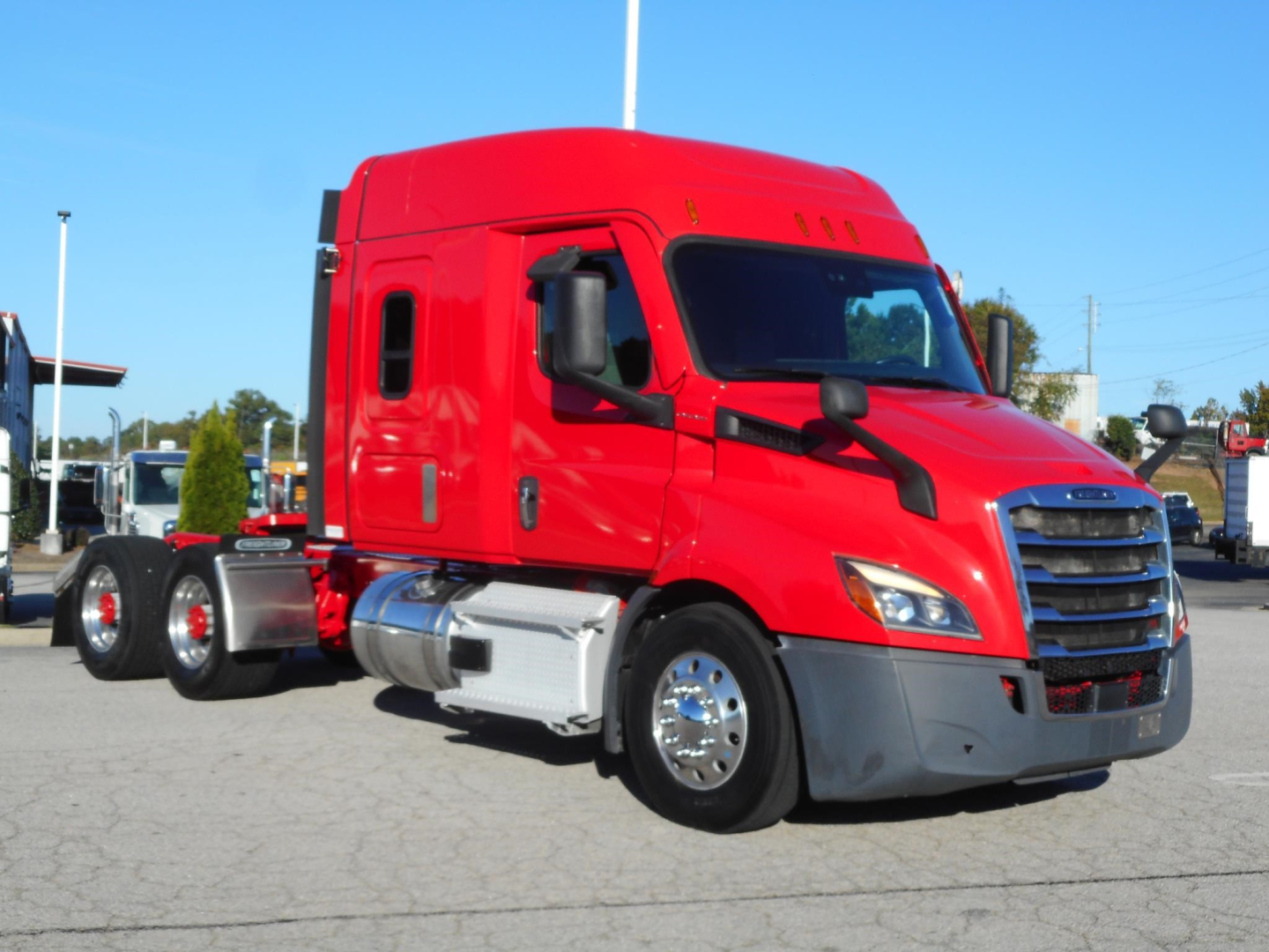 Red Freightliner Cascadia 116 highway truck, side view, with sleeper cab and dual rear axles, chrome fuel tanks, black mirrors, and front grille.