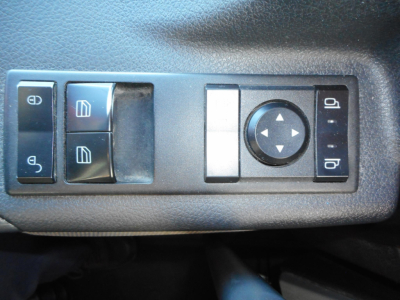 Freightliner Cascadia driver-side control panel with window and mirror controls visible