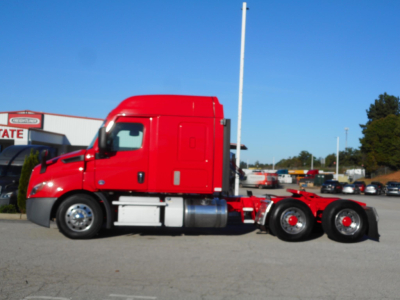 Tractor unit side view showing Freightliner Cascadia 116 cab and chassis with red exterior and twin rear axles.