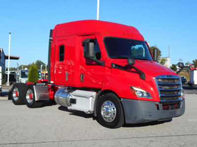 Red Freightliner Cascadia 116 highway truck, side view, with sleeper cab and dual rear axles, chrome fuel tanks, black mirrors, and front grille.