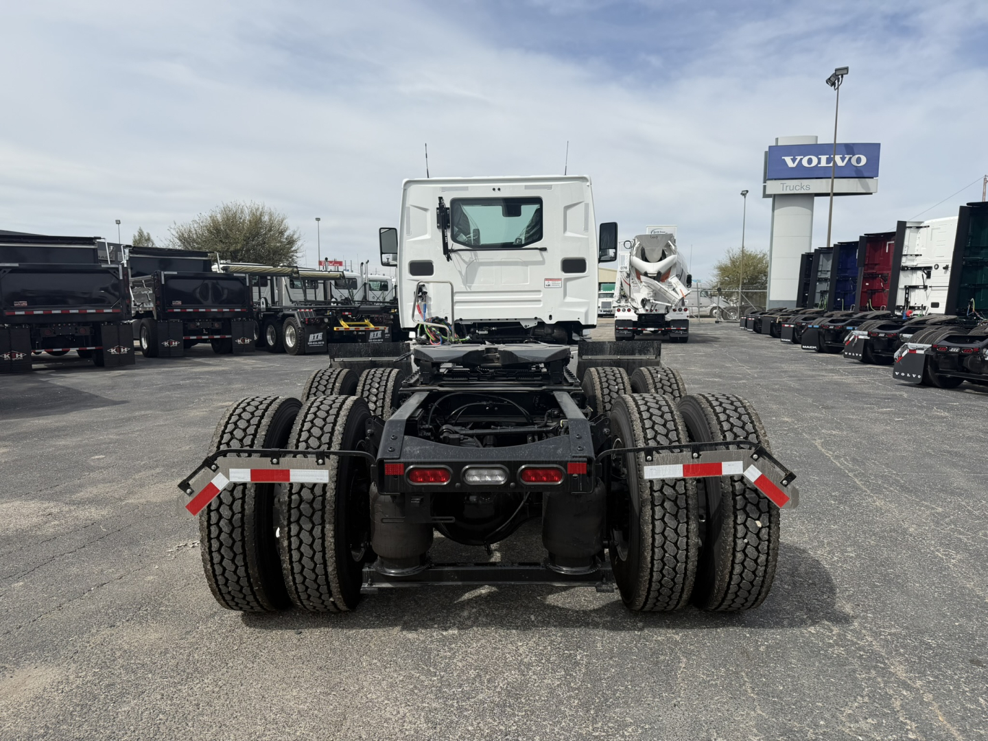 Truck chassis rear view showing dual rear axles, fifth wheel mount, and dual rear tires.