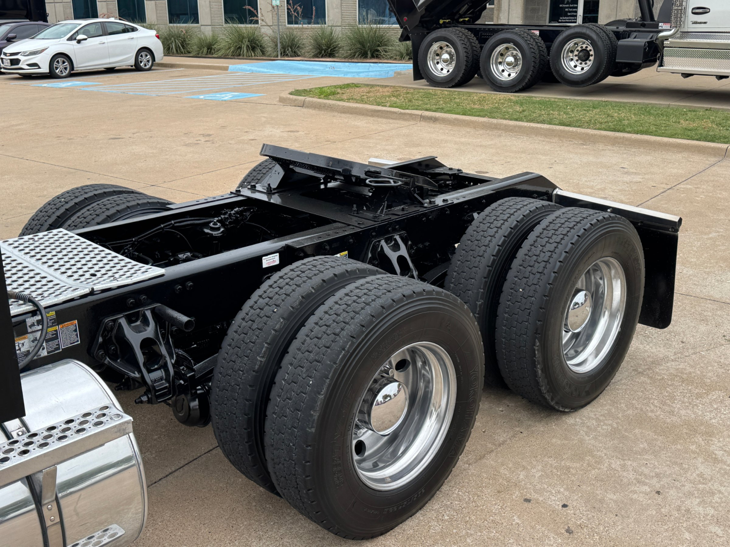Kenworth T880 conventional sleeper chassis with dual rear axles and heavy duty tires, chassis frame and fifth wheel mounting area visible.