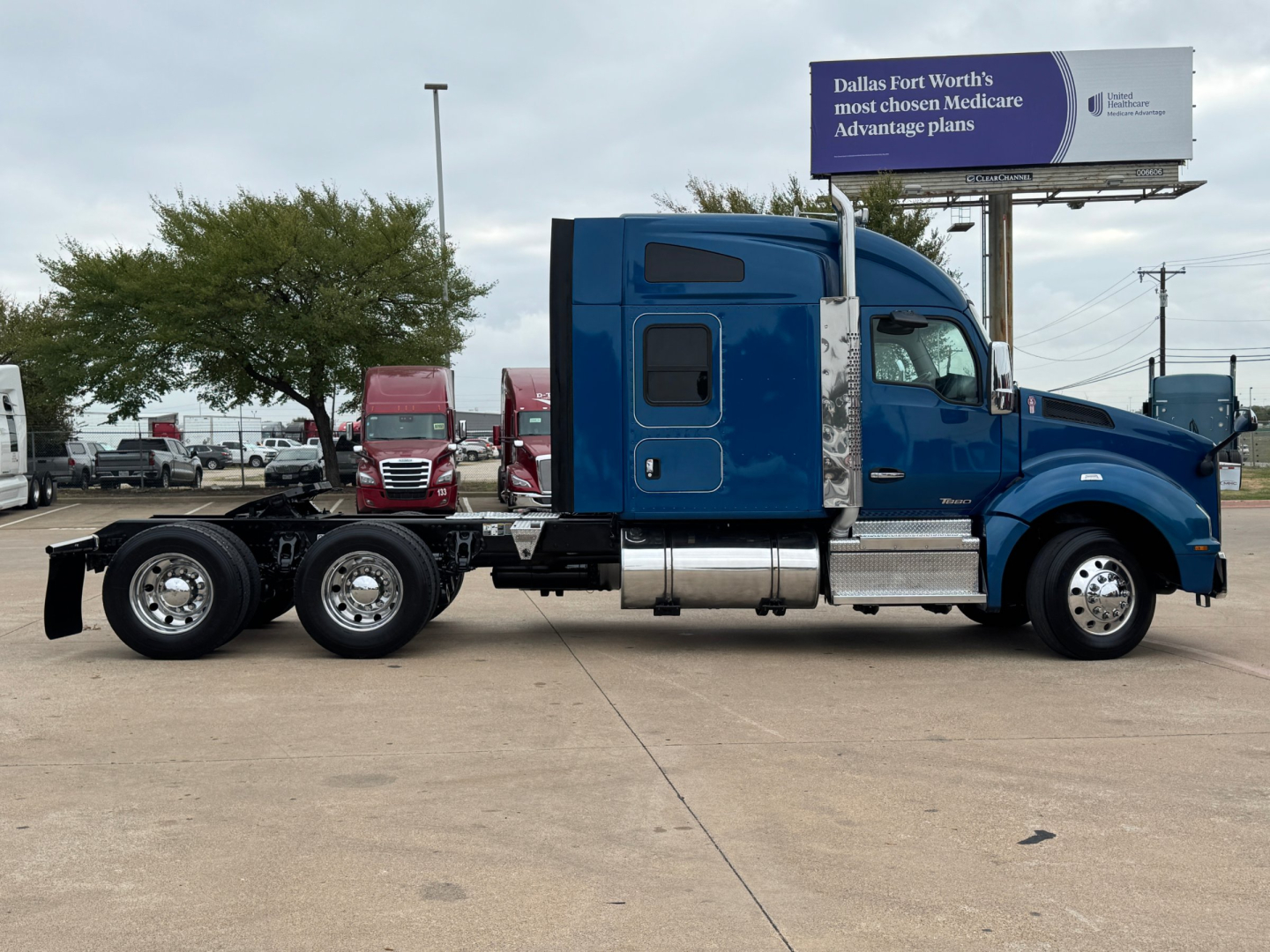 Kenworth T880 conventional sleeper truck side view showing cab and chassis with dual rear axles.
