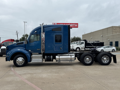 Blue 2019 Kenworth T880 conventional sleeper truck side profile showing cab, fuel tanks, and dual rear axles.