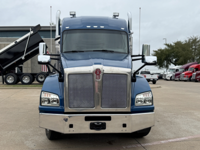 Front view of a blue 2019 Kenworth T880 truck with chrome grille, large bumper, and dual mirrors. No text visible on the image aside from vehicle styling.