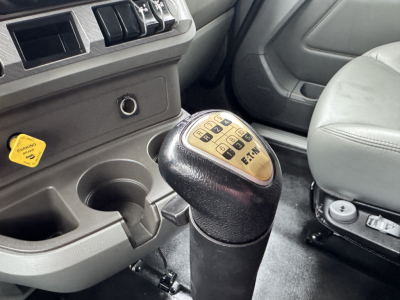 Kenworth T880 interior with manual gearshift knob showing shift pattern and dashboard controls.