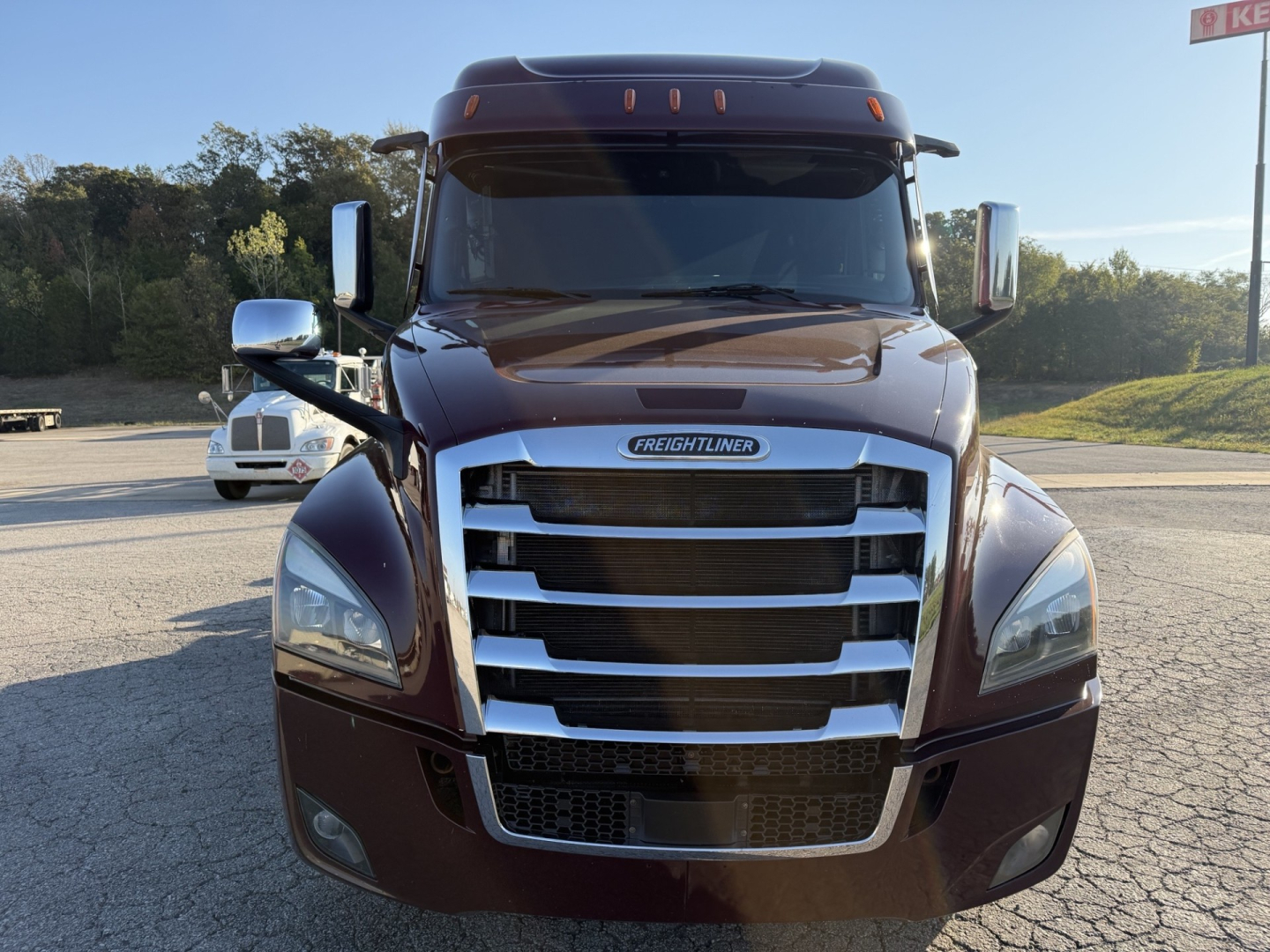 Freightliner Cascadia126 truck front view showing chrome grille, headlights, and Freightliner badge on hood.