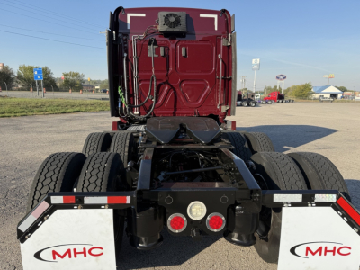 Freightliner Cascadia 126 tractor rear view showing chassis and mudflaps with MHC logos.