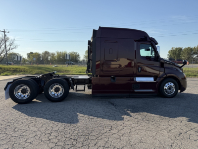 Freightliner Cascadia126 tractor shown in side profile with two rear axles, dark maroon paint, cab and chassis visible.