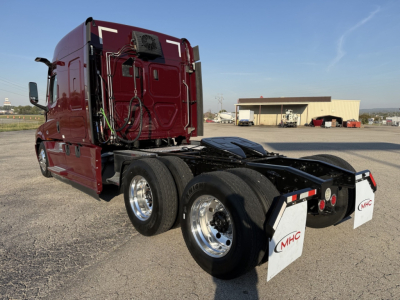 Freightliner Cascadia126 tractor side rear view showing dual rear axles and fifth wheel with MHC mudflaps