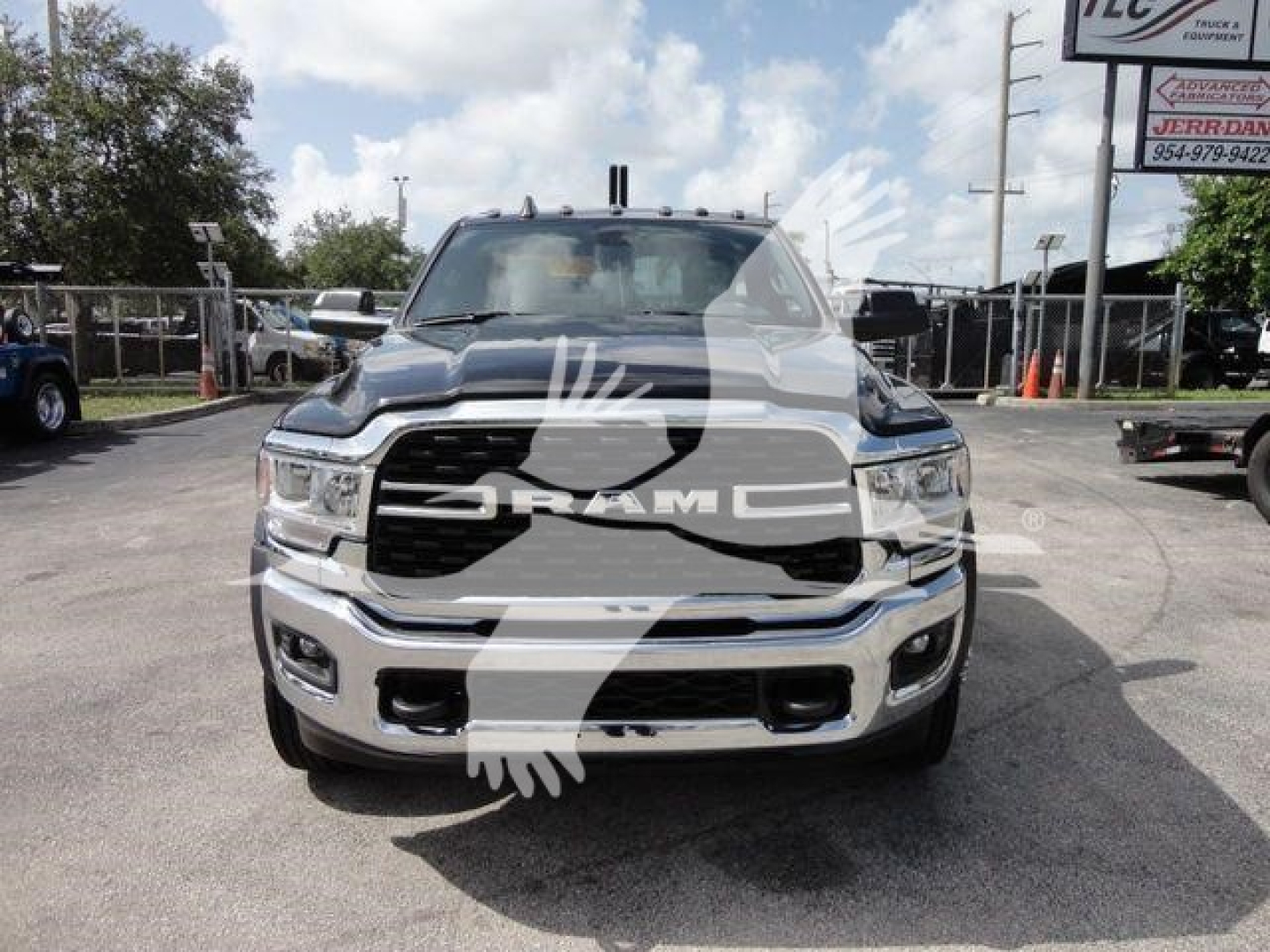Ram truck front view showing grille with RAM logo and bumper in-service, dealership lot background