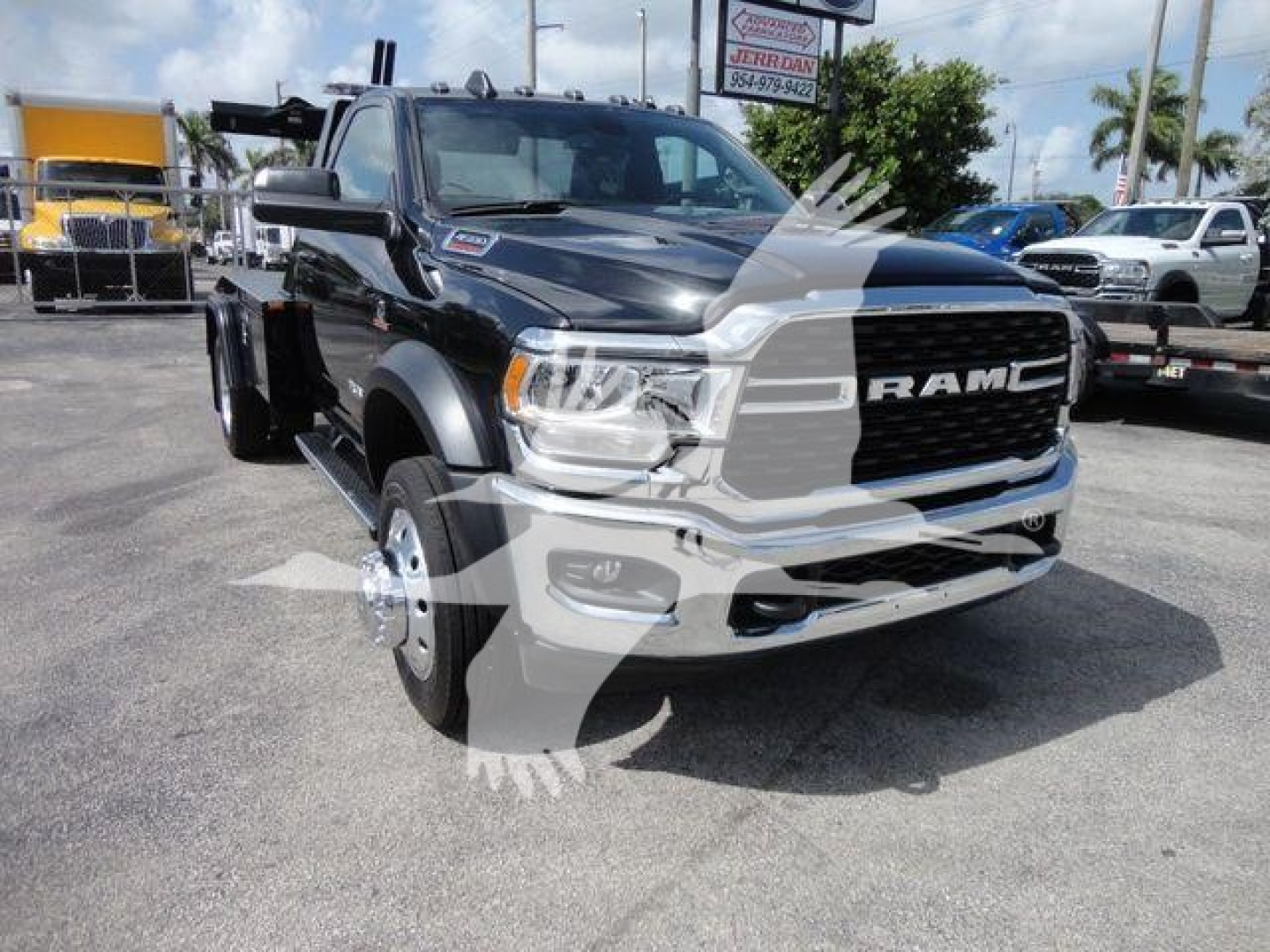 Ram 4500 Ram logo and front of black New Dodge Ram truck with large grille and wheel hubs visible.