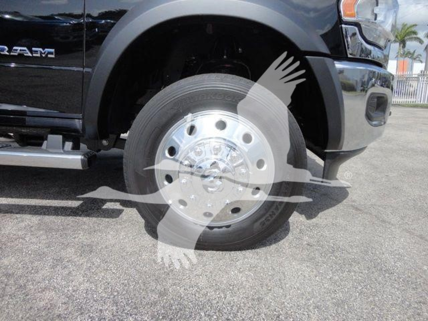 Ram 4500 front wheel view showing wheel and tire, front fender, and part of bumper with logo and steps.