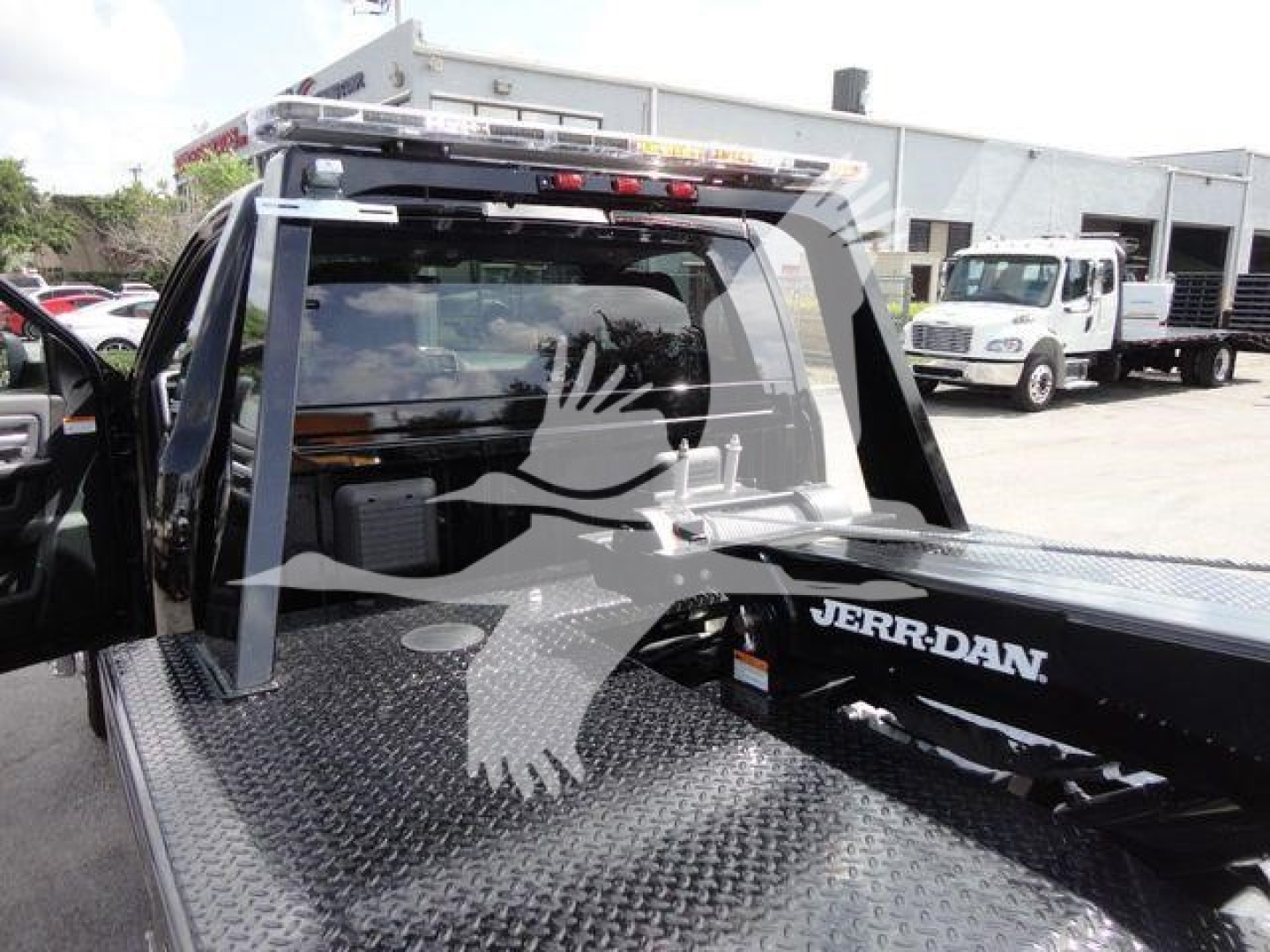 Ram 4500 pickup with a Jerr-Dan tow body; rear cab window; diamond plate bed; winch equipment visible; JERR-DAN branding on the bed; no visible license plates.