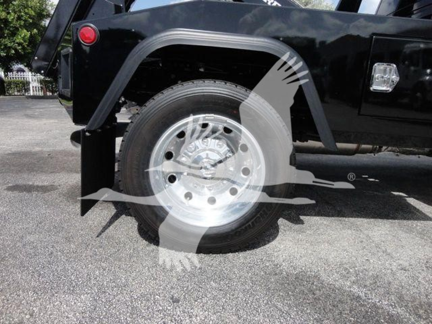 Truck wheel and fender area of a 2024 Ram 4500 SLT under a winch category setup; visible is a polished steel wheel with tire and part of the black vehicle body.