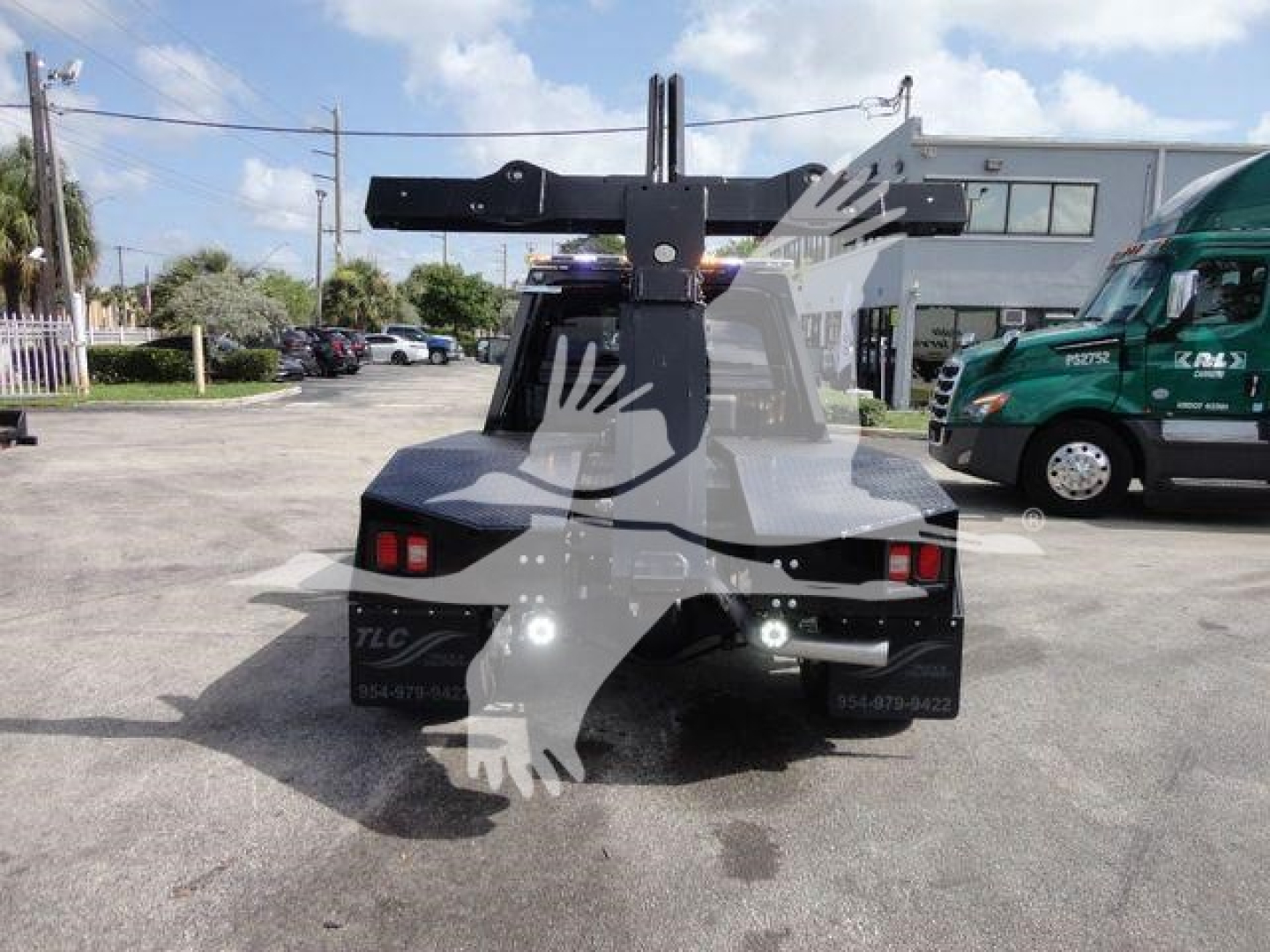 Back view of a 2024 Ram 4500 SLT truck with a mounted winch and heavy-duty hitch apparatus in the bed area.