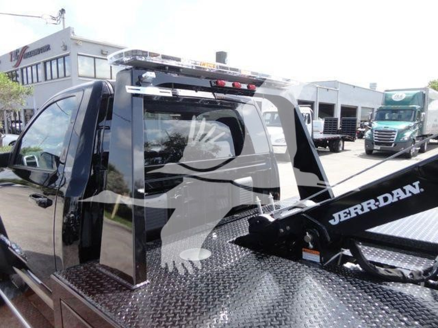 Ram 4500 pickup with a Jerr-Dan tow unit mounted on a diamond plate bed, side view showing cab and rear hoist, Winch category vehicle.