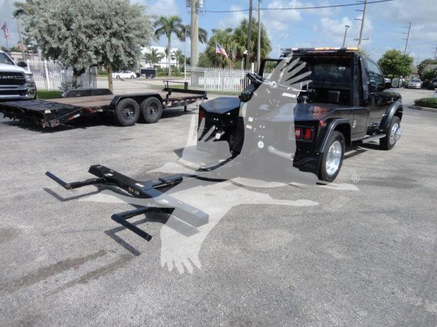 2024 Ram 4500 SLT conversion setup showing a front-mounted winch hitch and mounting hardware with a tow trailer in background.