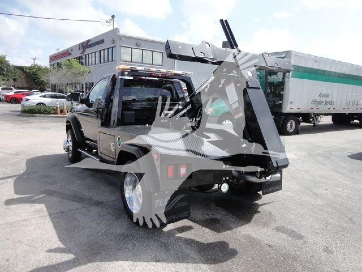 Ram 4500 SLT pickup truck with a mounted winch and heavy-duty rear equipment, visible in a dealership lot.
