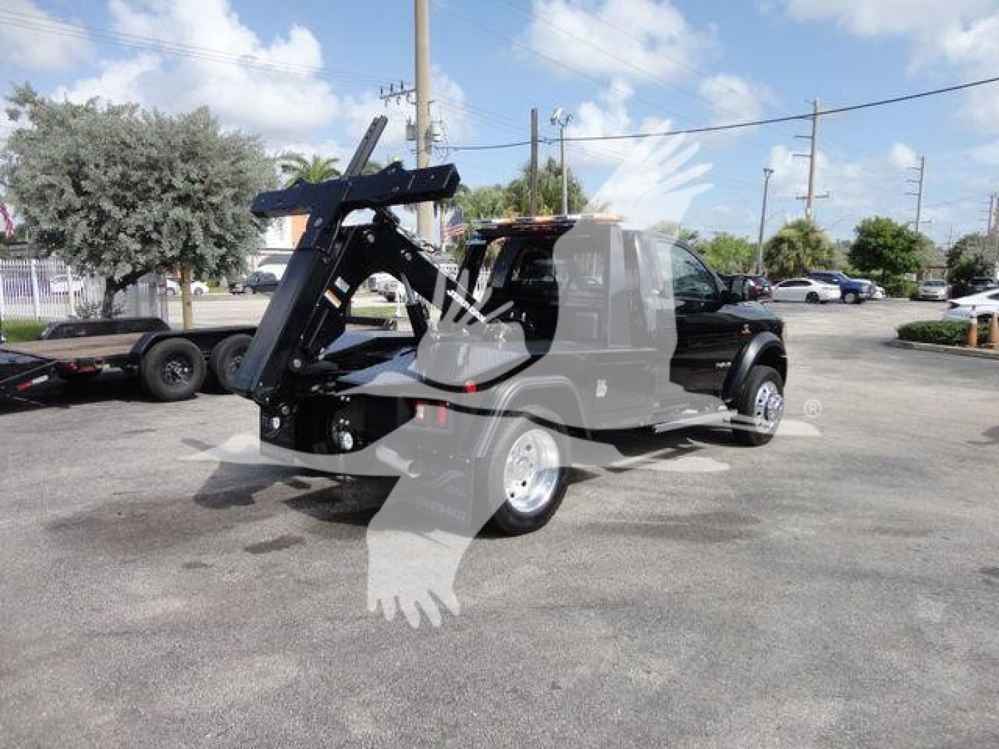 Ram 4500 SLT truck with heavy-duty winch system in a dealership lot, side view showing mounted crane/boom and front cab, stock number J33421FM.