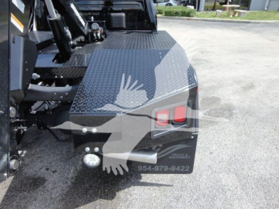 Truck bed area of a 2024 Ram 4500 SLT with diamond plate steel toolbox, winch equipment, and rear lights visible.