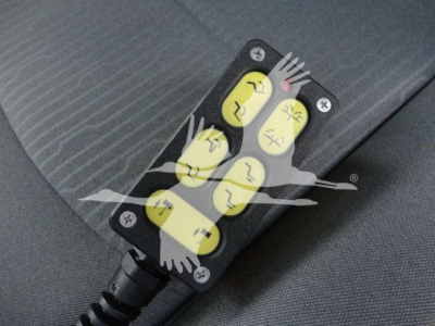 LED warning indicator panel with four yellow push buttons and black housing mounted on fabric surface.