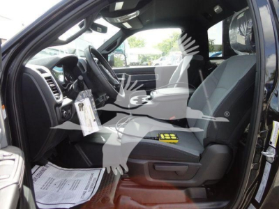 Ram 4500 cab interior showing front seats and steering wheel with dashboard text on sticker visible under steering wheel.