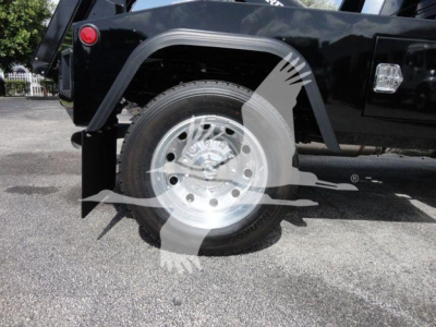 Truck wheel and fender area of a 2024 Ram 4500 SLT under a winch category setup; visible is a polished steel wheel with tire and part of the black vehicle body.