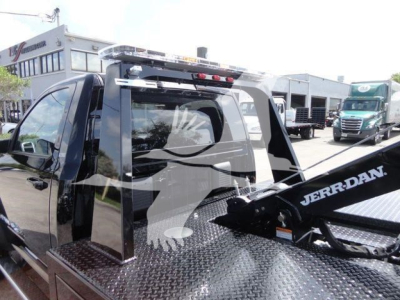 Ram 4500 pickup with a Jerr-Dan tow unit mounted on a diamond plate bed, side view showing cab and rear hoist, Winch category vehicle.