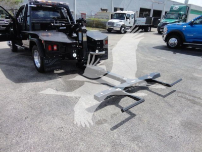 Truck with a mounted front winch and a metal recovery bar in an outdoor lot; Ram 4500 SLT, new with stock number J33421FM, winch category.
