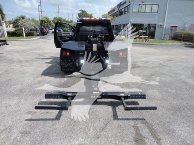 Ram 4500 SLT winch setup with pull bar bars on ground and truck in background.