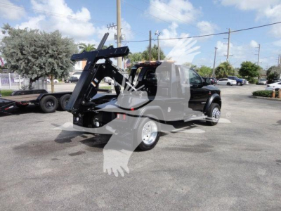 Ram 4500 SLT truck with heavy-duty winch system in a dealership lot, side view showing mounted crane/boom and front cab, stock number J33421FM.