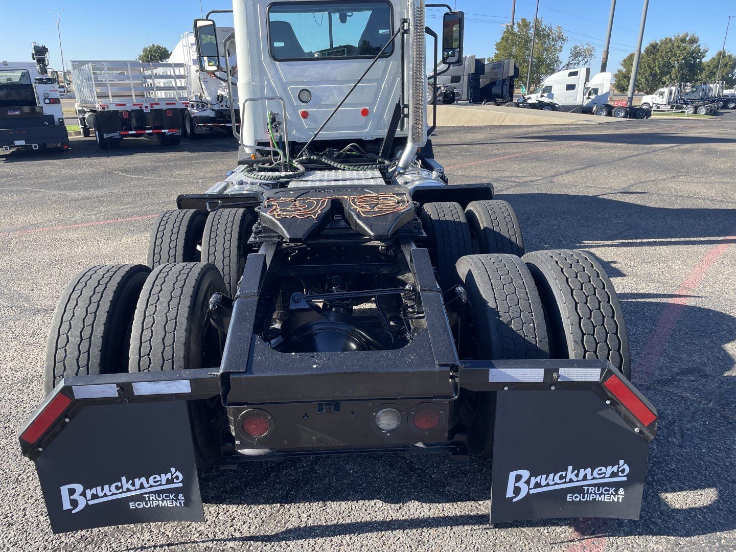 Rear view of a 2020 Mack AN64T daycab tractor chassis showing dual rear axles, fifth wheel, and mud flaps with Bruckner's logos.