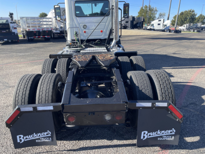 Rear view of a 2020 Mack AN64T daycab tractor chassis showing dual rear axles, fifth wheel, and mud flaps with Bruckner's logos.