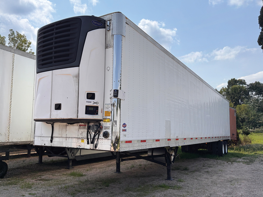 Utility 3000R trailer with rear refrigeration unit and front landing gear, side view showing reefer body and wheels.