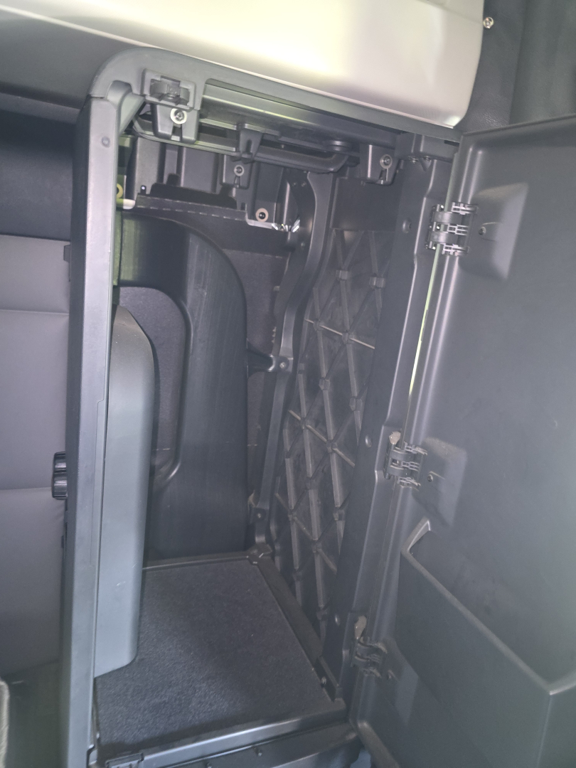 Cab interior showing a storage compartment area inside a Freightliner Cascadia truck cab.