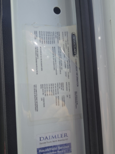 Freightliner Cascadia badge/plate showing vehicle identification and specifications inside door frame.