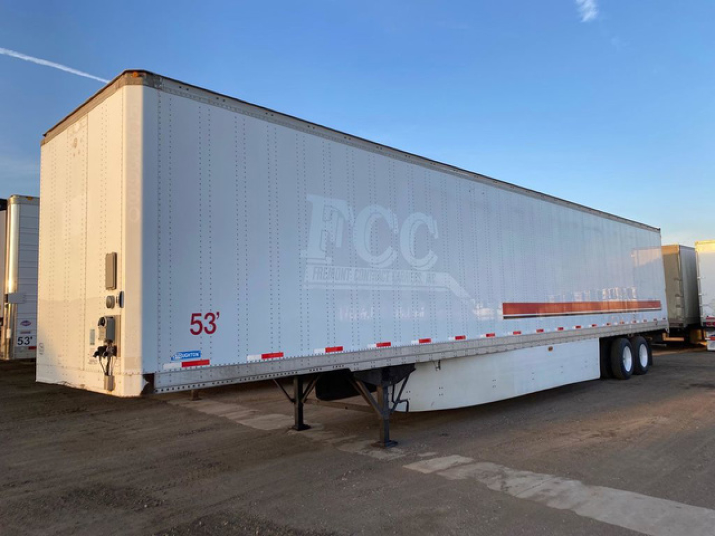 Van trailer showing a 53' Stoughton box with ECC logo, side decals, landing gear, and dual rear axles. Text visible includes 53' near front and white and light blue body.